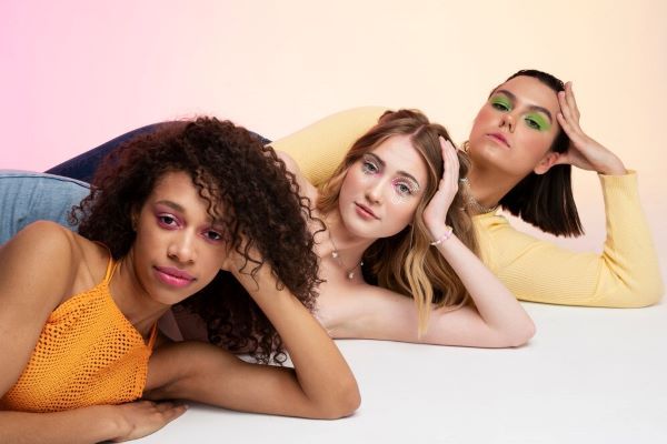 Scatto medio di ragazze in posa sul pavimento