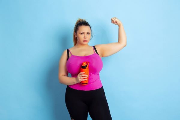 Ragazza in posa mostrando i suoi muscoli