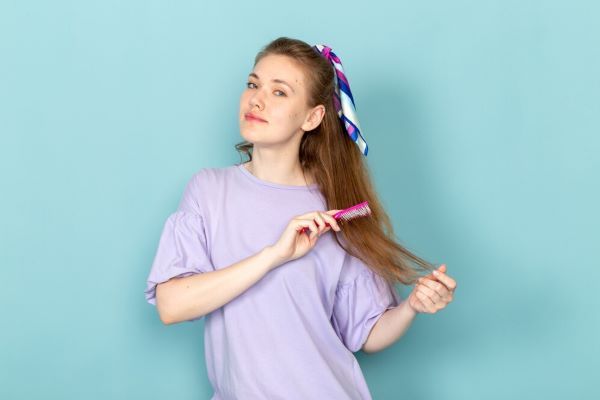 Ragazza che si pettina i capelli